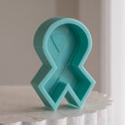 A high-performance Breast Cancer Ribbon Candle Mould silicone candle mold from MYKA Candles and Moulds for resin art and professional baking mould use.