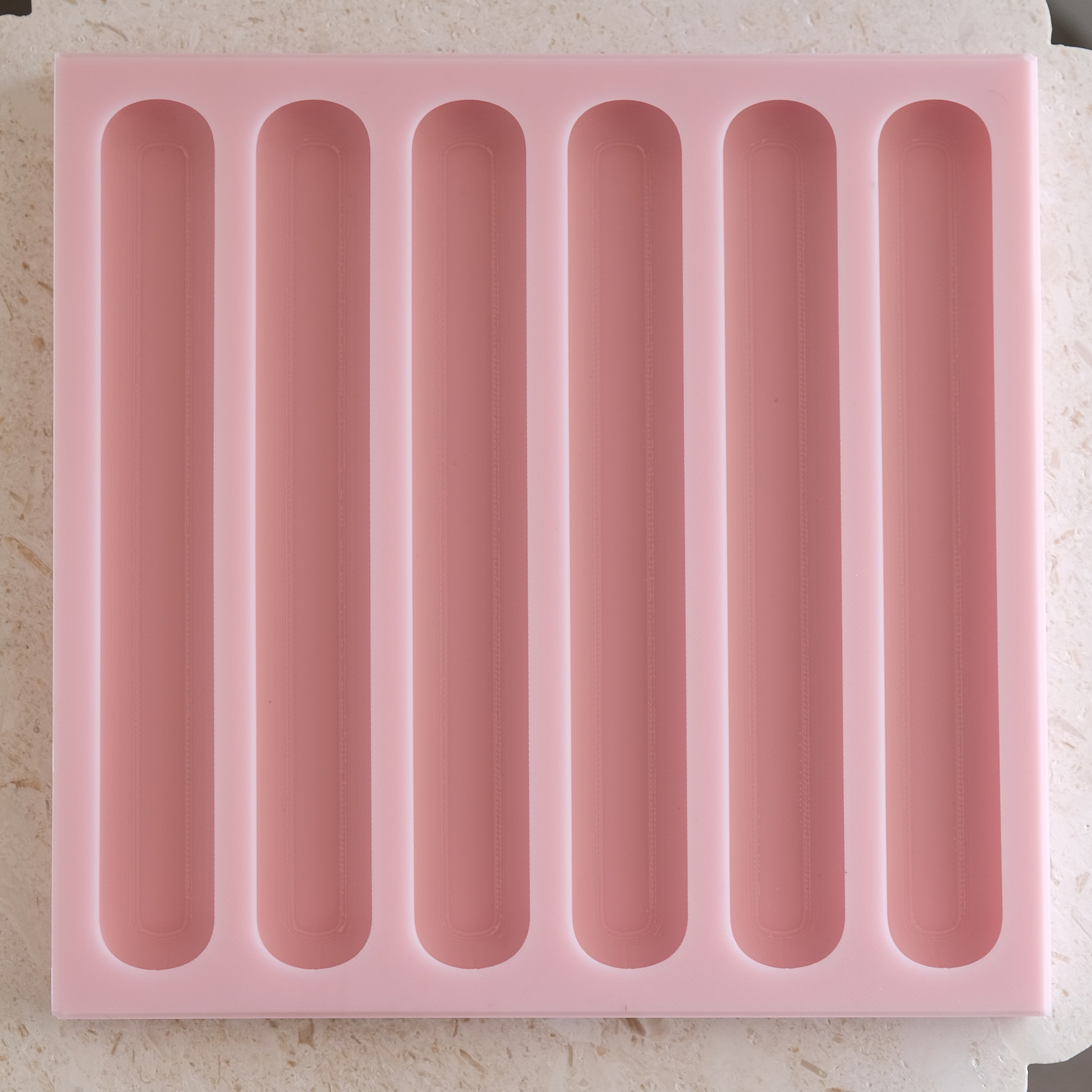 A heat-resistant Eclair Silicone Candle Mould silicone candle mould by MYKA Candles and Moulds, ideal for soap, resin, and baking mould applications.