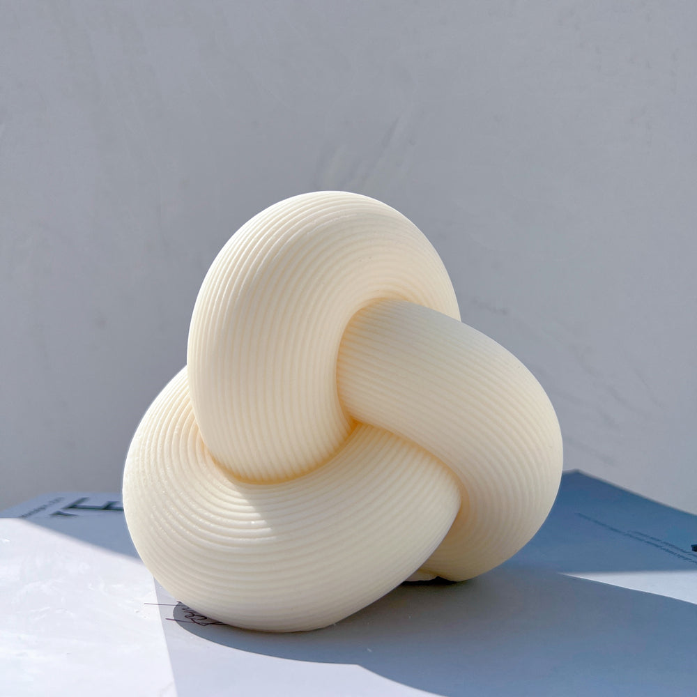 Precision-designed Ribbed Infinity Knot Candle Mould silicone candle mold by MYKA Candles and Moulds for resin moulds and gourmet cake mould designs.