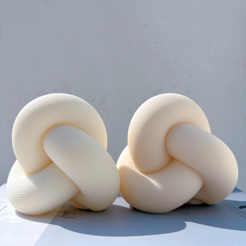 The Ribbed Infinity Knot Candle Mould silicone candle mould by MYKA Candles and Moulds, a top choice for artistic resin moulds and baking moulds.